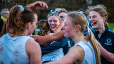 women's blues celebrating varsity win